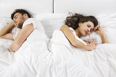 A weak man, depressed woman lying in bed